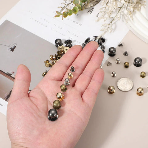 Hand holding Bronze Ball Head Leather Rivet Set 20 Pieces with various sizes, Chicago Style for handbags and belts repairs.