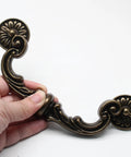 Close-up of Vintage Drop Bail Drawer Pulls 6 Inch Center To Center 150mm Bronze Zinc Alloy Cabinet Handles with floral design.