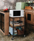 Multifunctional 3 Tier Rolling Cart On Wheels With Storage In Brown For Kitchen Bar Pantry Bathroom And Office Sturdy Metal Frame And Wood Shelves Versatile Utility Cart For Small Spaces shown in kitchen with dishes and microwave