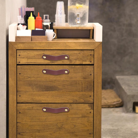 Wooden dresser with 4 Pack Leather Cabinet Handles With Screws, soft brown leather pulls, fitted in a kitchen setting.
