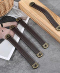 4 Piece Leather Cabinet Pulls And Luggage Handles Replacement Brown Leather Drawer Pulls for cabinets on wooden surface with screws