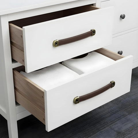 Brown leather cabinet pulls installed on white drawers, part of 4 Piece Leather Cabinet Pulls And Luggage Handles Replacement with screws.