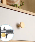 Eight Piece Brushed Brass Cabinet Knob Set With Solid Round Hardware for kitchen cabinets shown installed on drawer