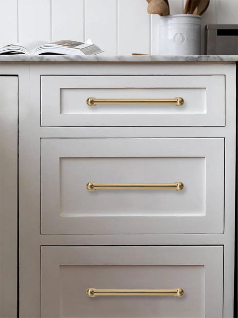 Two Pack 12 Inch Center To Center Brushed Brass Cabinet Pulls Set on white dresser with modern design