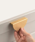 Installing a 4 Pack Half Moon Finger Pull with 3 Inch Center Hole in Brushed Brass Gold on a cabinet drawer.