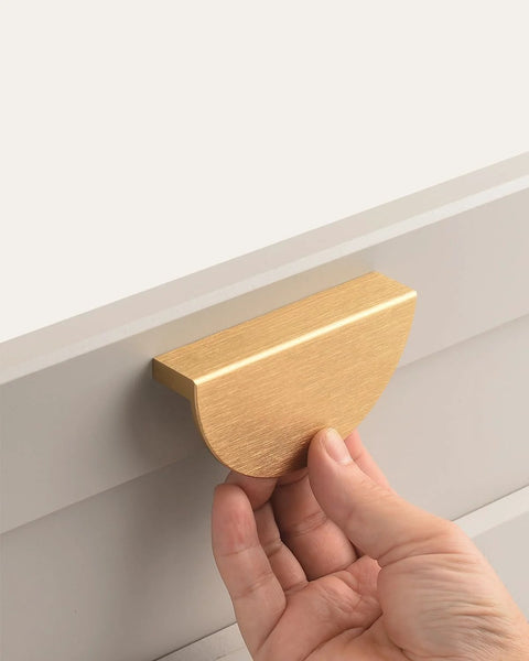 Installing a 4 Pack Half Moon Finger Pull with 3 Inch Center Hole in Brushed Brass Gold on a cabinet drawer.