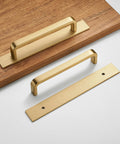 Solid Brass Cabinet Pull With Backplate Set Of 2 in Brushed Gold Finish with one installed on wood surface, modern 5 inch handles