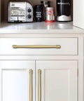 2 Pack 4 Inch Center To Center Brushed Gold Cabinet Pulls installed on white kitchen cabinets