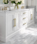 Bathroom vanity with 20 Pack Brushed Gold Cabinet Handles Five Inch Kitchen Cabinet Pulls in solid zinc alloy, installed on white doors.