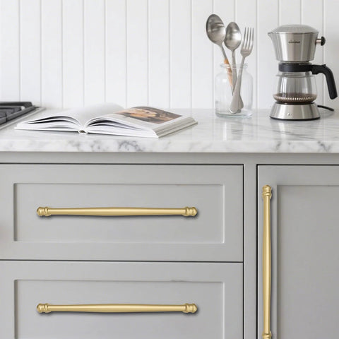 2 Pack 4 Inch Center To Center Brushed Gold Cabinet Pulls installed on gray kitchen drawers with marble countertop