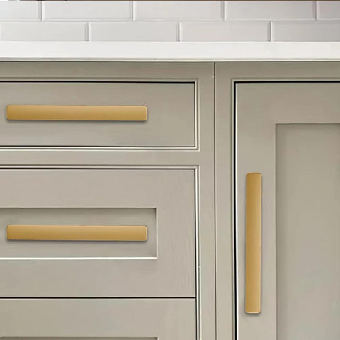 Brushed Gold Cabinet Pulls 4 Inch 2 Pack Solid Zinc Alloy Drawer Handles installed on gray kitchen cabinets
