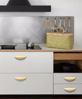 Brushed Gold Crescent Cabinet Pulls Two And A Half Inch Hole Centers installed on modern kitchen drawers
