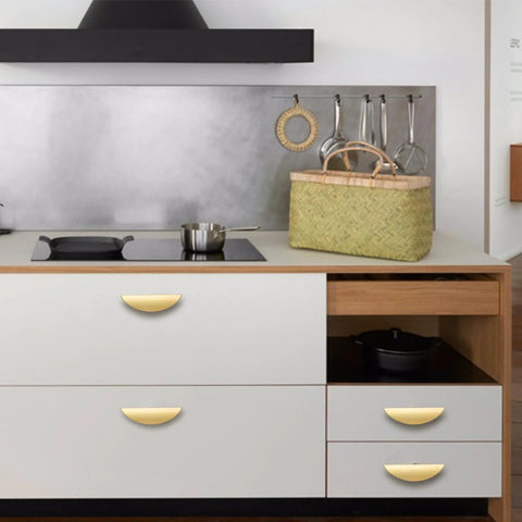 Brushed Gold Crescent Cabinet Pulls Two And A Half Inch Hole Centers installed on modern kitchen drawers