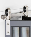 Close-up of 28 Inch Brushed Nickel Bifold Sliding Barn Door Hardware Track Kit With Side Mounted J Shape Rollers, installed view.