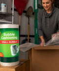 Bubble Wrap Protective Packaging 12 Inch Wide 30 Foot Roll Clear Bubble Cushions For Delicate Items being used to pack a box