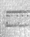 Close-up of Bubble Cushioning Wrap For Fragile Items Perforated 12 Inch Roll 175 Ft Clear With Small Three Sixteenth Inch Bubbles with ruler