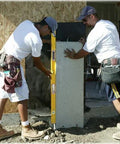 Two builders using Stabila 37448 48-Inch Builder's Level with reinforced frame and three vials on a concrete wall for accuracy