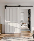 Bypass Sliding Barn Door Hardware Kit With Single Track System In Frosted Black Carbon Steel installed on white barn doors.