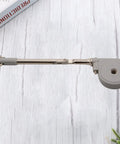 Satin silver Drop Down Short Cabinet Door Gas Strut Hydraulic Gas Spring with sturdy construction on a wooden background