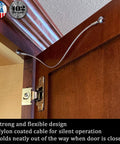Stainless Steel Cabinet Door Restraint Kit installed on wood cabinet, showing braided cable limiting door swing. Made in USA.