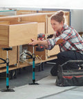 Woman using adjustable support poles, cabinet jacks for installing cabinets, telescoping support poles range from 13.8'' to 24.6'', 2 packs