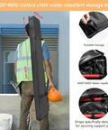 Worker carrying water-repellent storage bag for Cabinet Jack, showcasing portable design and strap details