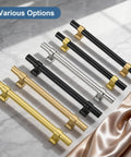 Various cabinet pulls in black, gold, and silver finishes displayed on marble surface.