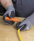 Five In One Cable Stripping Tool For 12 To 14 AWG NM Cable Jacket Slitting And Precision Insulation Stripping in use by electrician