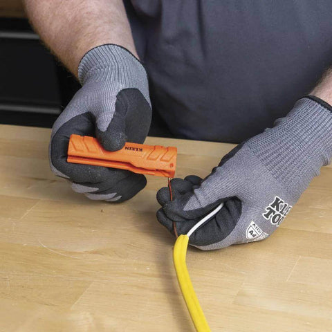 Five In One Cable Stripping Tool For 12 To 14 AWG NM Cable Jacket Slitting And Precision Insulation Stripping in use by electrician