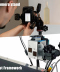 Photographer adjusts camera on stand; test framework setup for equipment testing in studio environment.