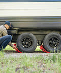 Person using Camper Leveler Block With Rubber Mat for RVs and Trailers, precise leveling from one half inch to four inches.