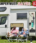 Two people relaxing outside a camper van with camping essentials like a water bottle, umbrella, and bag attached to the side.