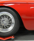 Red car on Car Dolly Replacement Casters Set of 4-1500 Lbs. Capacity showing front wheel and dolly in garage setting.