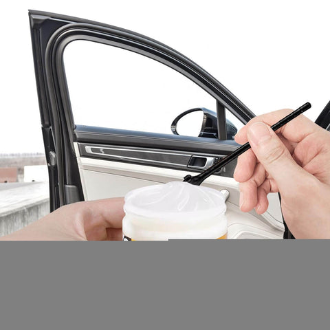 Applying Door Car Grease Multifunctional Rails Lubricant on car door hinge with brush, enhancing smooth operation for sunroof hinges and locks.