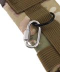 Close-up of a carabiner attached to a camouflage fabric strap