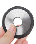 Close-up view of a disc-shaped key-cutting blade with serrated outer edge and central hole.
