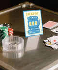 Casino Slot Machine Cutting Dies for Card Making and Scrapbooking displayed with playing cards and chips on a table.
