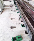 Heavy Duty Cast Iron Machine Leveling Feet Pads Set installed, supporting CNC machinery on uneven floor in industrial setting