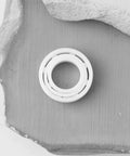2 Pcs MR137 Full Ceramic ZrO2 Ball Bearings 7x13x4mm on a textured surface for optical instruments and machinery