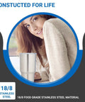 Woman holding Ceramic Interior 30oz Wine Tumbler With Lid Double Wall Vacuum Insulated For Cold Or Hot Drinks in a cozy setting.