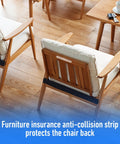 Wooden chair with white cushion and anti-collision strip on wooden floor near table and magazine