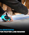 Person using chalk line reel with blue chalk on surface, highlighting 6:1 gear rewind feature for fast line retrieval.