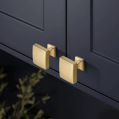 Champagne Bronze 10 Pack Cabinet Knobs Single Hole Drawer Pulls for Kitchen and Bedroom Cabinets installed on dark cabinet doors.