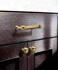 Champagne Bronze Cabinet Knobs Set of Ten, One and One Quarter Inch Round Zinc Alloy Drawer Knobs on dark wood cabinets