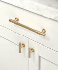 10 Pack Champagne Bronze Cabinet Pulls 5 Inch 128mm installed on white kitchen cabinet with marble countertop