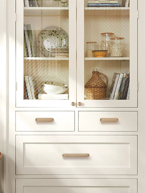 Champagne Bronze Cabinet Pulls 3 Inch Hole Center Circle Drawer Handles Zinc Alloy Hardware installed on white cabinet drawers.