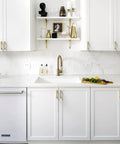 White kitchen with Champagne Bronze Cabinet Pulls 10 Pack 3 Inch Hole Center Zinc Alloy Handles installed on cupboards and drawers.