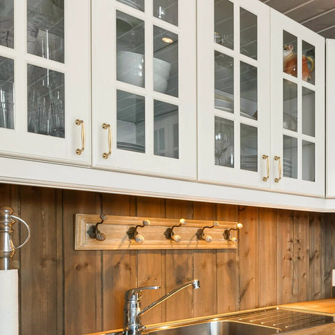 Kitchen cabinets with 20 Pack 3-3/4 Inch Champagne Bronze Kitchen Cabinet Handles installed on white doors.
