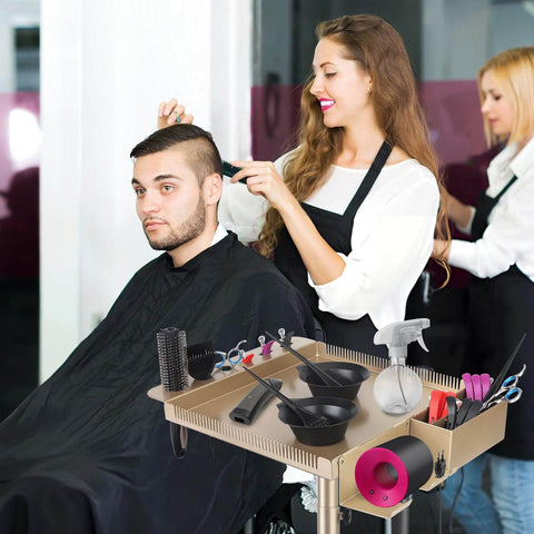 Champagne Gold Pro Grade Hair Salon Cart with wheels and height adjustable tray in use during a haircut at a salon.