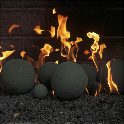 Charcoal Gray 2 inch Ceramic Fire Balls - 30-Pack - Brushed Concrete Look, Speckled, arranged in outdoor fire pit with flames.